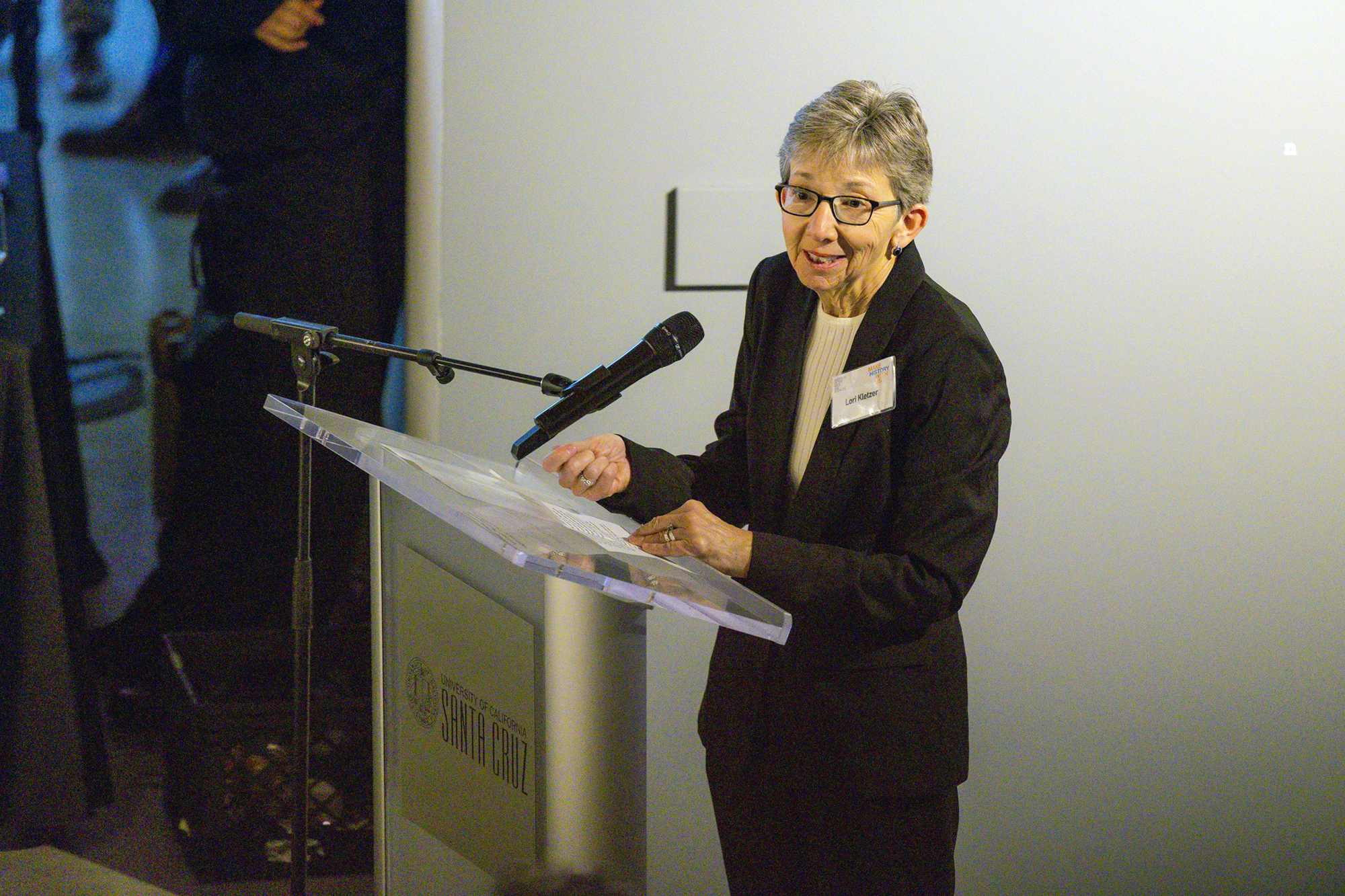 Lori Kletzer speaking at a podium