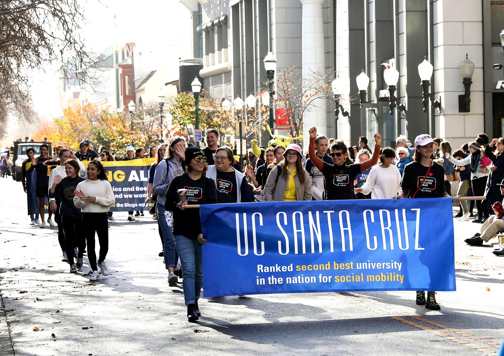 Students, staff and chancellor marching in holiday day parade in downtown Santa Cruz.