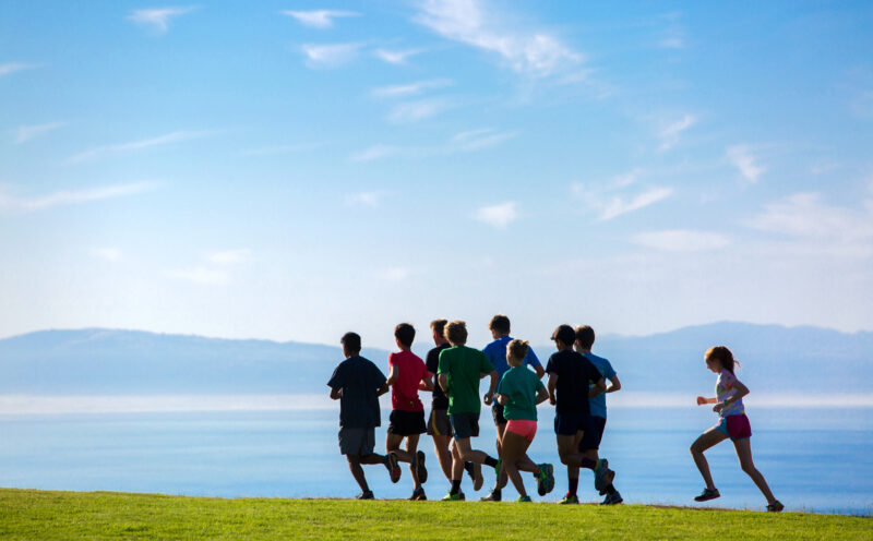 Students running on the East Field over looking the Monterey Bay.
