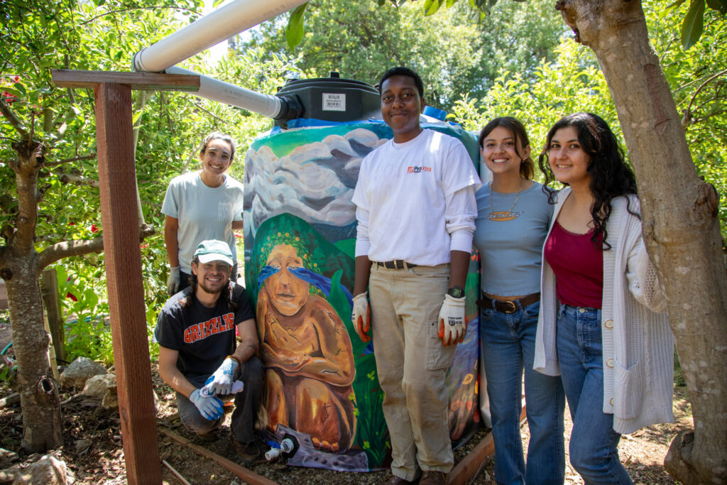 Students stood next to water container