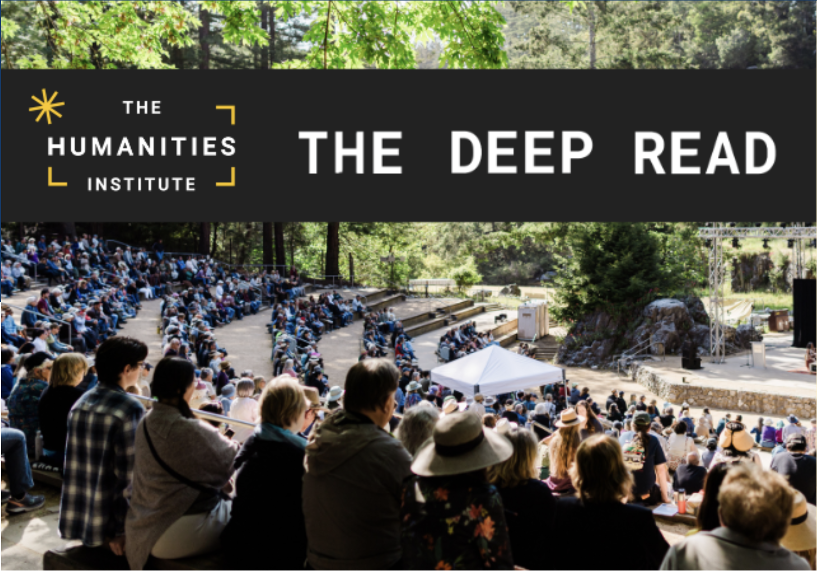A crowd sits in the quarry amphitheater