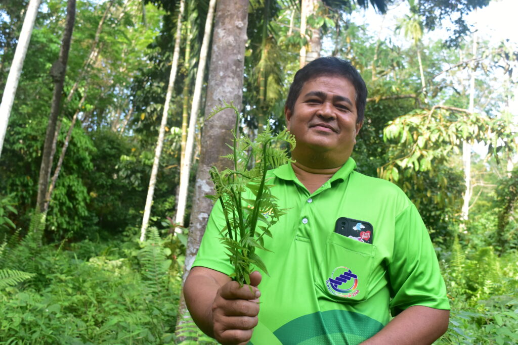 farmer with tree in hand
