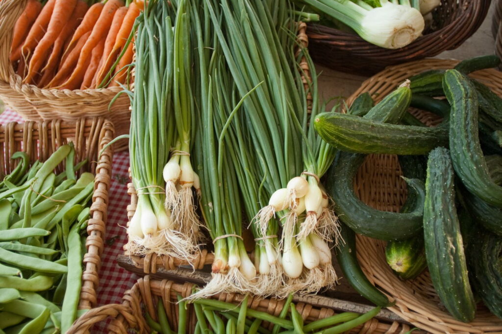 Fresh produce arranged in woven baskets.